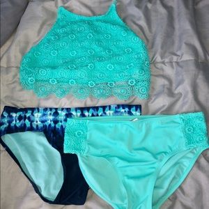 A bathing suit top with two matching bottoms